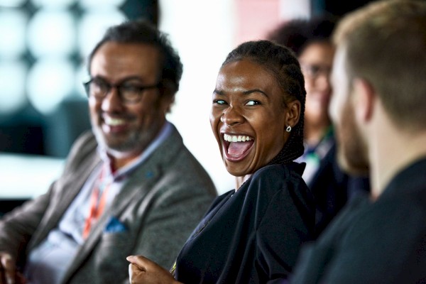 Photo of people laughing and looking at each other