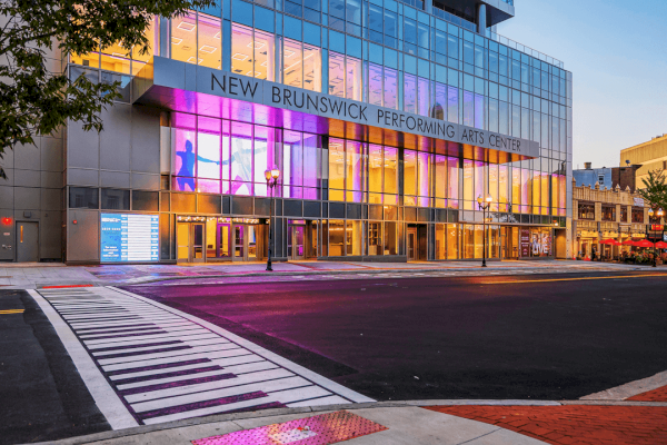 photo of crossing path with theater in front in an evening set up