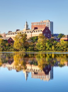 Photo of skyline with water body on front, and buildings on the back